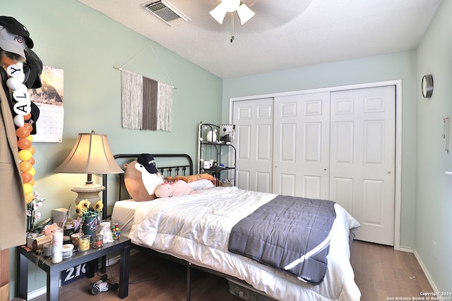 bedroom with ceiling fan, a closet, and hardwood / wood-style flooring