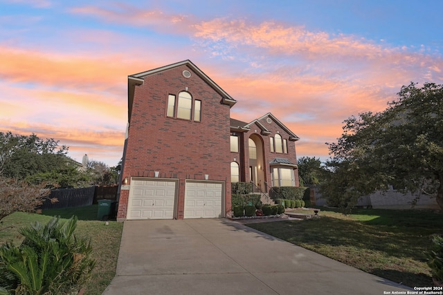 view of property featuring a yard and a garage