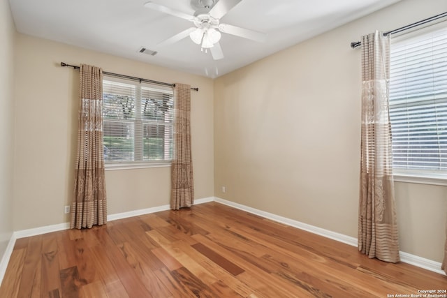 spare room featuring ceiling fan and hardwood / wood-style floors