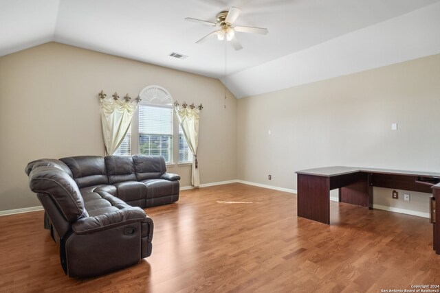 living room featuring ceiling fan, wood-type flooring, and lofted ceiling