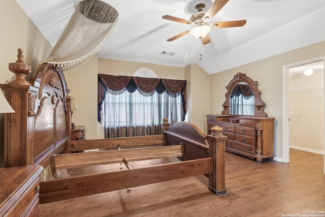 interior space with hardwood / wood-style floors, ceiling fan, and vaulted ceiling