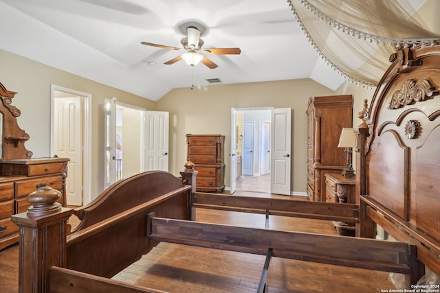 bedroom featuring hardwood / wood-style floors, ceiling fan, and lofted ceiling