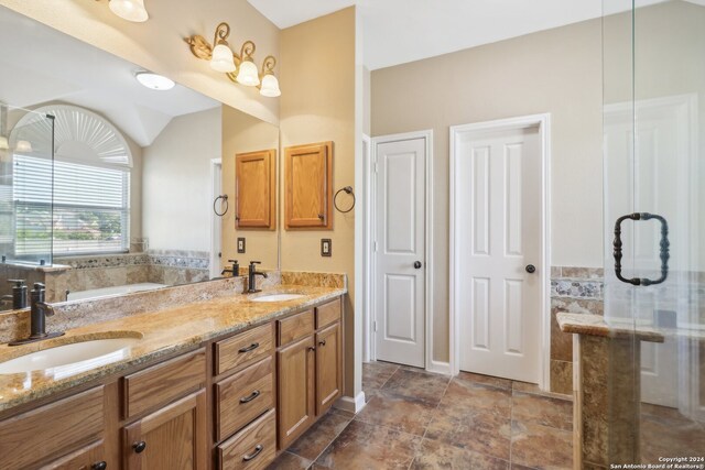 bathroom with vanity, walk in shower, and vaulted ceiling