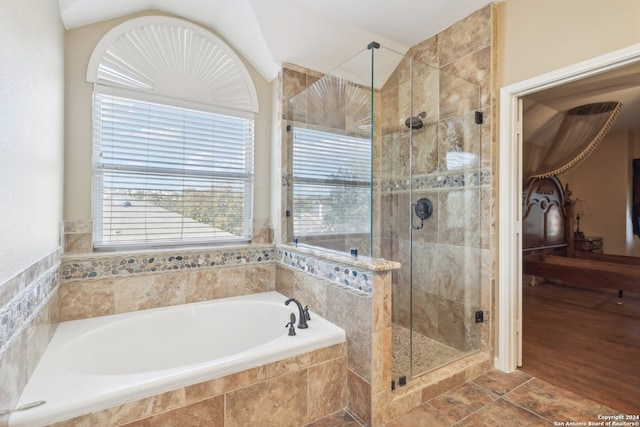 bathroom featuring hardwood / wood-style flooring and plus walk in shower