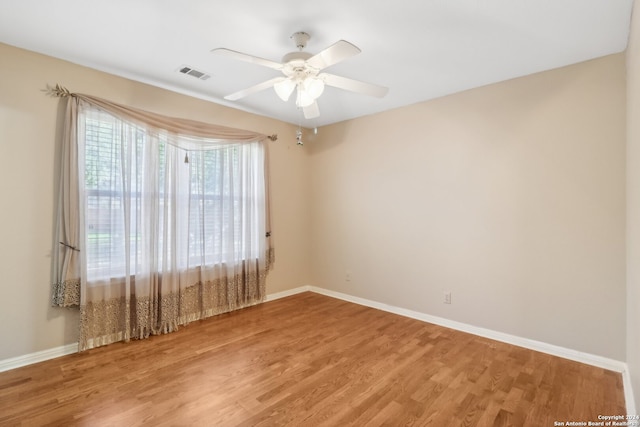 spare room with hardwood / wood-style flooring and ceiling fan