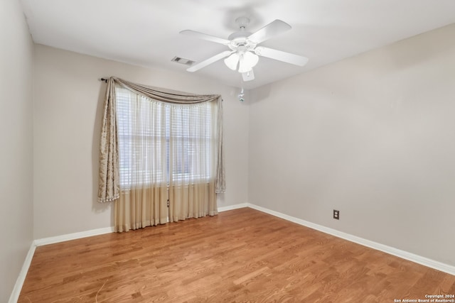 spare room with ceiling fan and wood-type flooring