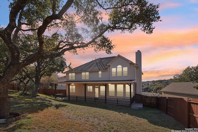 back house at dusk with a yard