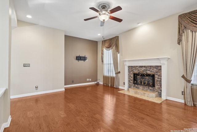 unfurnished living room featuring wood-type flooring and ceiling fan