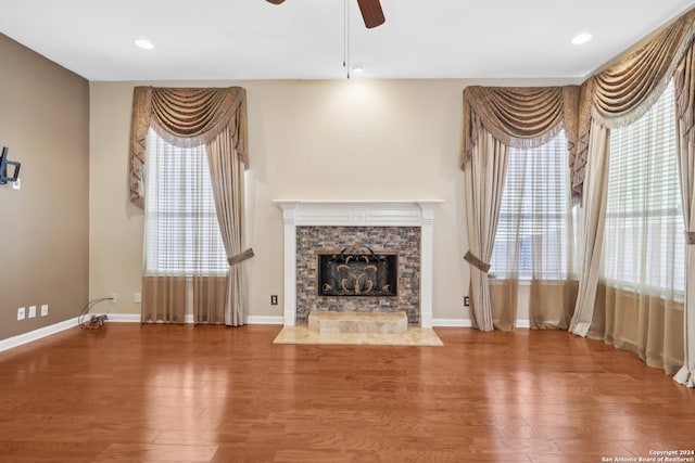 unfurnished living room featuring a fireplace, ceiling fan, and hardwood / wood-style floors