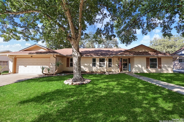 ranch-style house with a garage and a front lawn