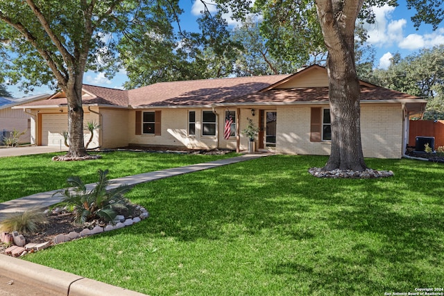 ranch-style home featuring a garage and a front yard