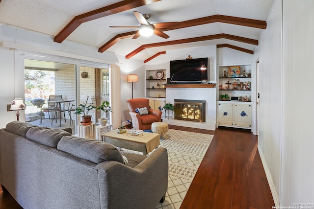 living room featuring dark hardwood / wood-style flooring, lofted ceiling with beams, a textured ceiling, and built in features