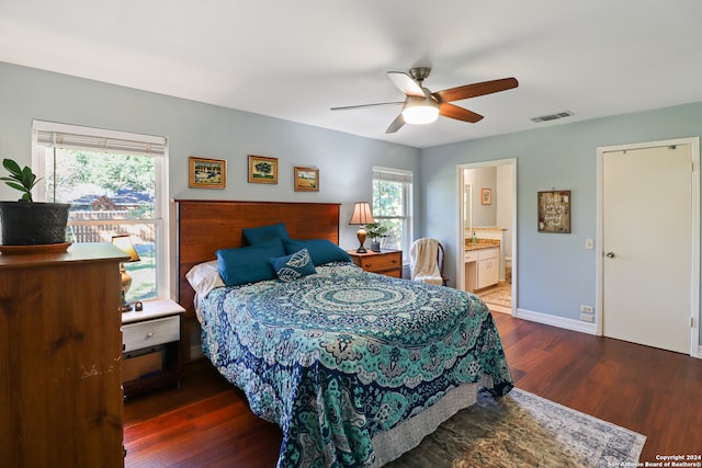 bedroom with dark hardwood / wood-style flooring, ensuite bath, and ceiling fan