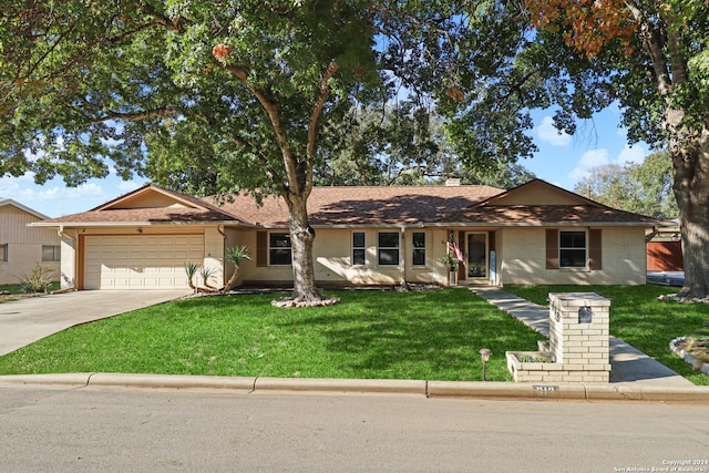 ranch-style home with a garage and a front yard