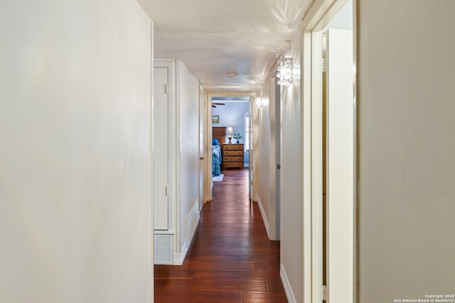 corridor with dark hardwood / wood-style flooring