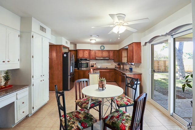 kitchen with backsplash, sink, ceiling fan, light tile patterned flooring, and stainless steel appliances