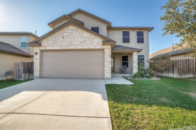 view of front of home with a garage and a front lawn