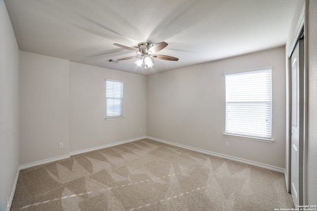 carpeted empty room with ceiling fan