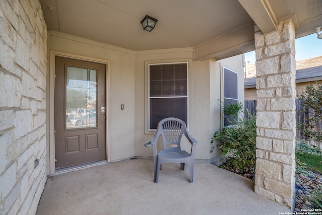 view of exterior entry featuring a patio