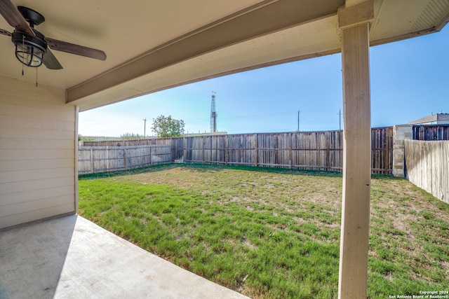 view of yard with ceiling fan and a patio