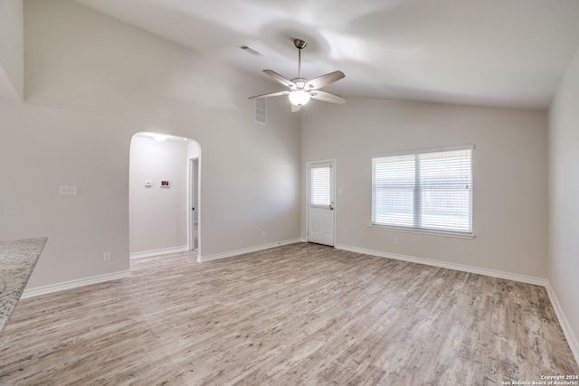 empty room featuring high vaulted ceiling, light hardwood / wood-style flooring, and ceiling fan