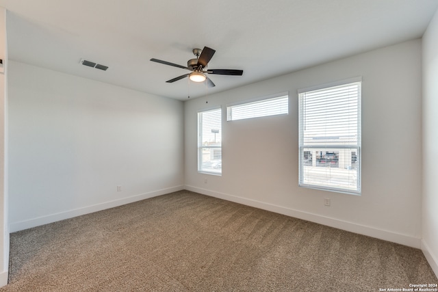 spare room featuring carpet and ceiling fan