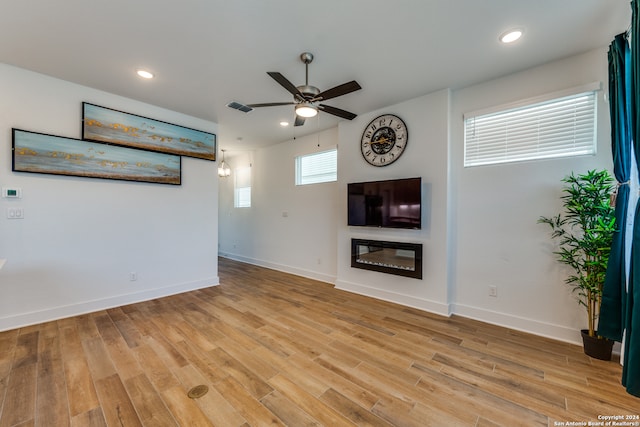 unfurnished living room featuring ceiling fan and light hardwood / wood-style flooring