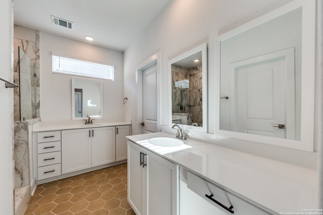 bathroom featuring tile patterned floors, vanity, and tiled shower