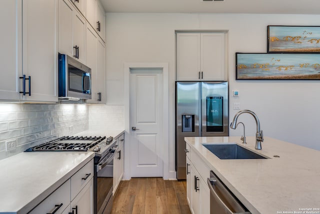 kitchen featuring white cabinetry, sink, light wood-type flooring, and stainless steel appliances