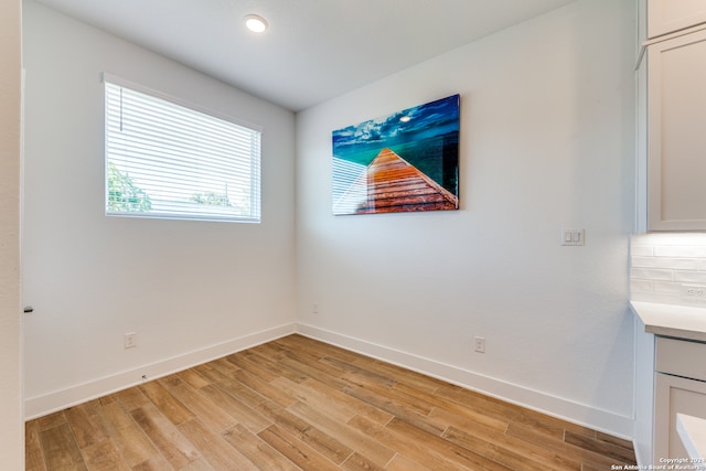 spare room with light wood-type flooring