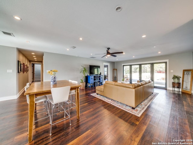 living room featuring ceiling fan and dark hardwood / wood-style flooring