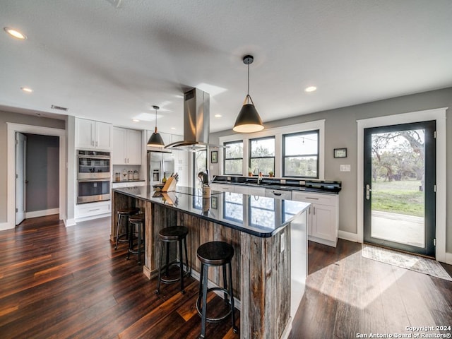 kitchen featuring a center island, dark hardwood / wood-style floors, white cabinetry, island exhaust hood, and stainless steel appliances