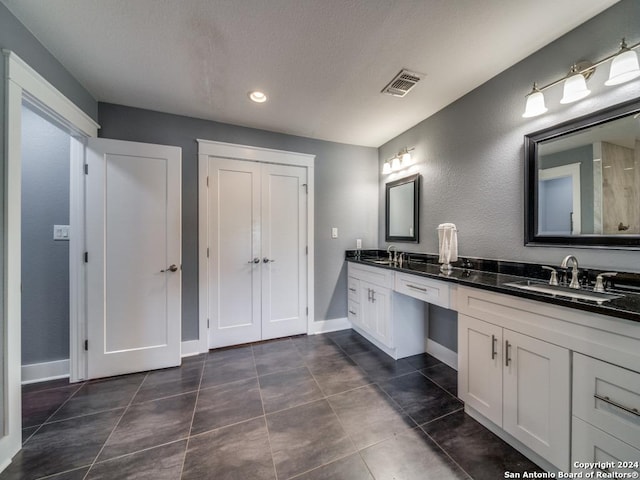 bathroom with tile patterned floors and vanity