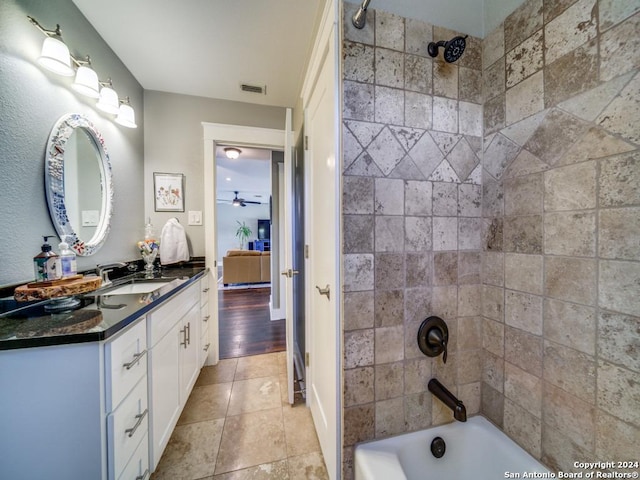 bathroom featuring vanity, hardwood / wood-style flooring, tiled shower / bath, and ceiling fan