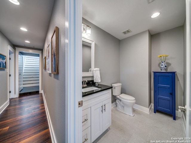 bathroom featuring hardwood / wood-style floors, vanity, and toilet