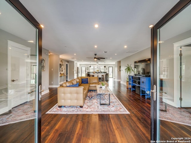 living room with dark hardwood / wood-style floors, ceiling fan, and french doors