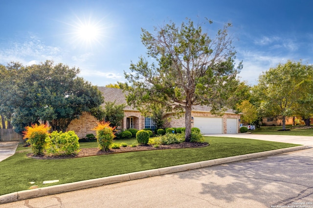 view of front of home with a front yard and a garage