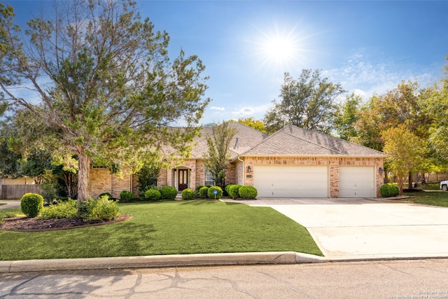 view of front of home featuring a garage and a front yard