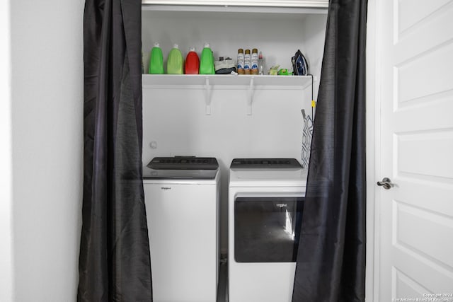 washroom with washing machine and clothes dryer