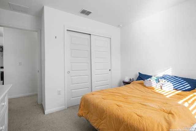 carpeted bedroom with a closet