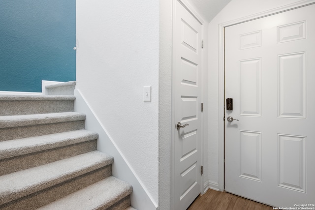 staircase featuring hardwood / wood-style flooring