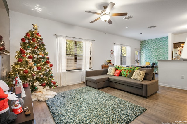 living room with hardwood / wood-style floors and ceiling fan