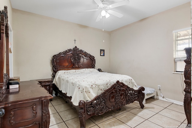 tiled bedroom featuring ceiling fan