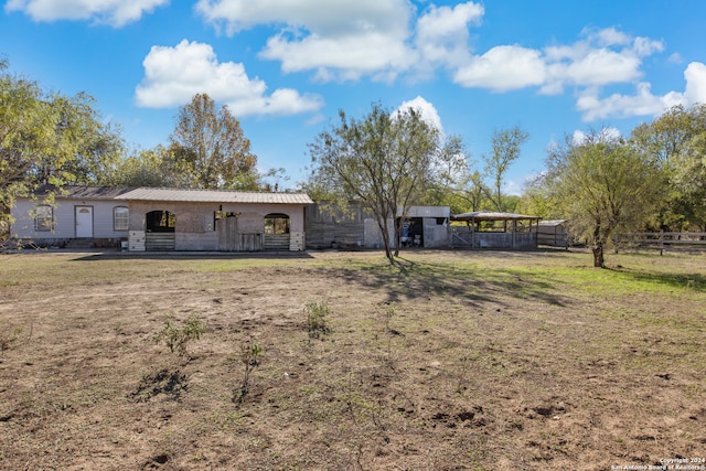 rear view of property featuring an outbuilding