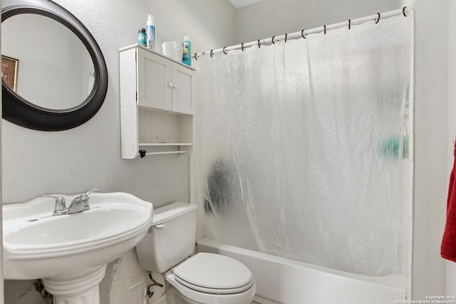 full bathroom with shower / bath combo, toilet, and sink