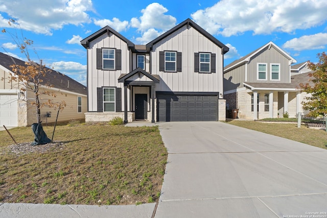 view of front of house with a garage and a front lawn