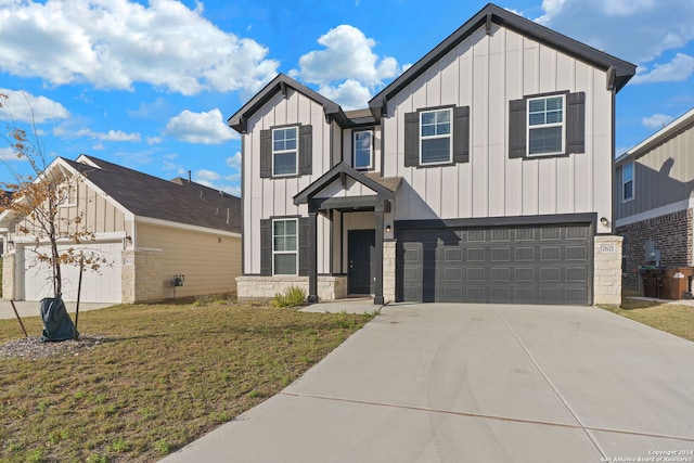 view of front of property featuring a front yard and a garage