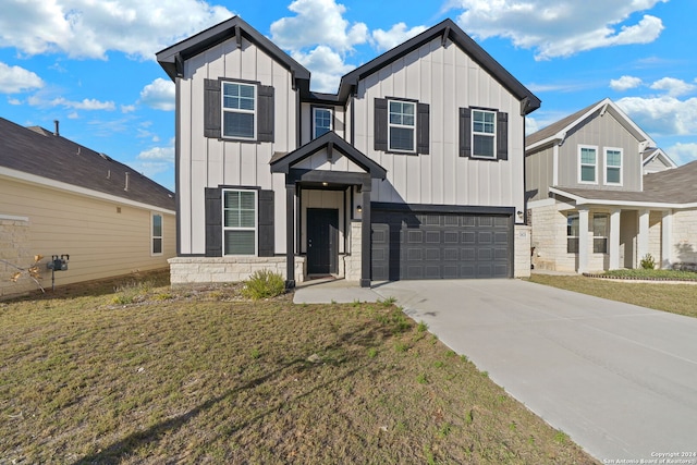 view of front of home with a garage and a front lawn