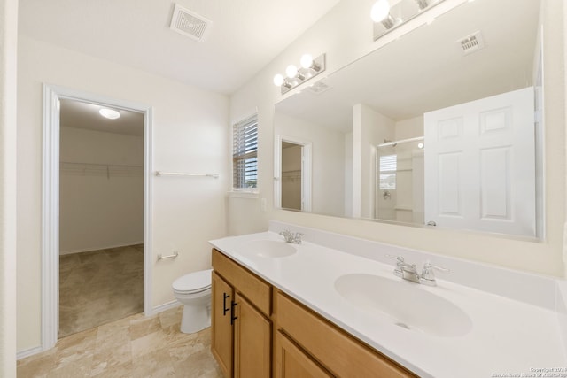 bathroom with vanity, toilet, and walk in shower