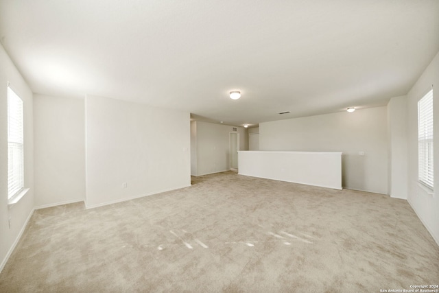 carpeted spare room with plenty of natural light